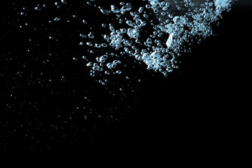 Wall Mural - Pouring water has an abstract bubble on a black background