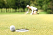 © amenic181 - Woman golfer cheering after a golf ball on a golf green