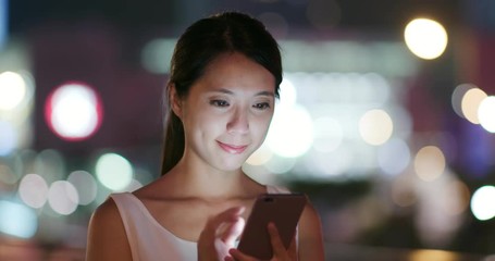 Wall Mural - Asian Woman use of mobile phone in city at night