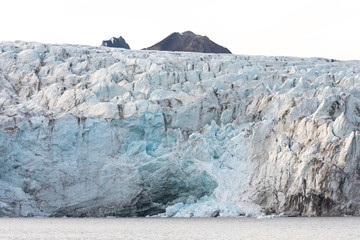 Wall Mural - isfjorden glacier front of blue ice in svalbard on a summer day.