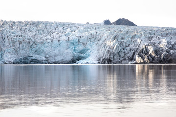 Wall Mural - isfjorden glacier front of blue ice in svalbard on a summer day.