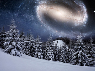 Wall Mural - starry sky in winter snowy night. fantastic milky way in the New Year's Eve. The Milky Way is a fantastic New Year's Eve. Courtesy of NASA