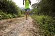 Asian woman trail running on mountain