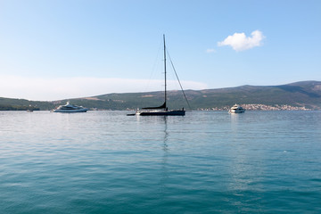 Two sailing ships yachts black and white at Adriatic sea A large luxury private motor yacht under way on sea with bow wave