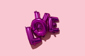 Poster - letter-shaped balloons forming the word love.