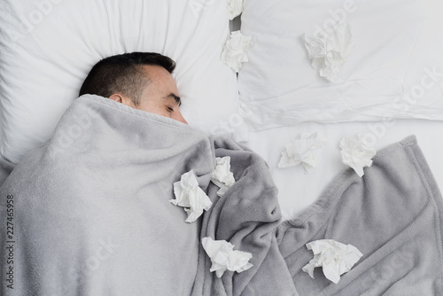Cuadros en Lienzo ill man in bed surrounded by used tissues