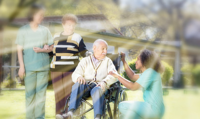 Poster - Two female doctors helping elderly man and woman with physical disability ih rehab facility garden