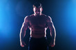© yurakrasil - Muscular torso of sexy young fitness male bodybuilder model power athletic man with perfect muscles six pack abs and bare nude chest posing on dark background