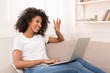 © Prostock-studio - Happy african-american woman making video call on laptop