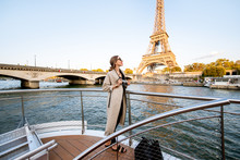 Young Woman Enjoying Beautiful Landscape View On The Riverside With Eiffel Tower From The Boat During The Sunset In Paris