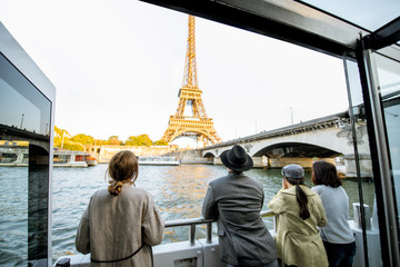 people enjoying beautiful landscape view on the riverside with eiffel tower from the boat during the