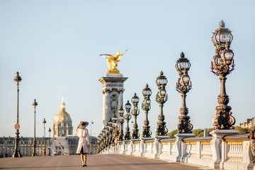 Wall Mural - View on the famous Alexandre bridge with beautiful woman walking during the morning view in Paris