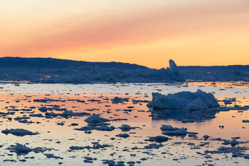 Wall Mural - midnight sun lighting up the glacier. disko bay, greenland.