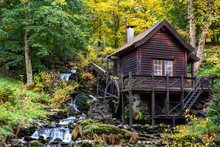 An Old Water Mill Next To A Water Stream In Bergen Norway
