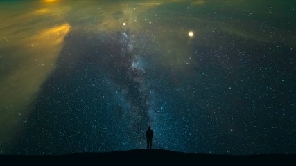 Wall Mural - The male standing on a mountain on the starry sky background. time lapse