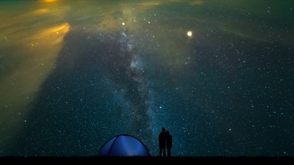 Wall Mural - The man and a woman near a camping tent standing on the meteor shower background