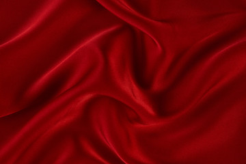 Red silk fabric background, view from above. Smooth elegant red silk or satin luxury cloth texture can use as abstract background with copy space. 
