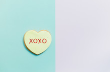 Pale Valentine Candy Cookies With Messages Over Pastel Background