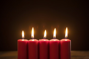 Wall Mural - Five candles burning in dark background