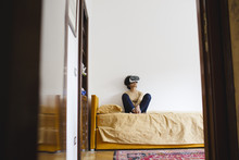 Woman Sitting On The Bed With Virtual Reality Headset
