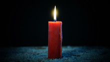 Red Candle Burning On Dark Background