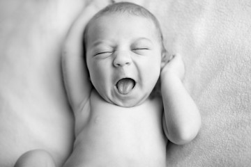 happy newborn baby boy with a big smile