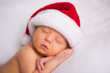 Christmas Newborn Baby Wearing Santa Hat And Sleeping