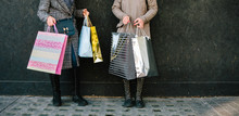 Anonymous Shot Of Two Women Walking Holding Shopping Bags