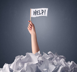 Wall Mural - Female hand emerging from crumpled paper pile holding a white flag with help written on it