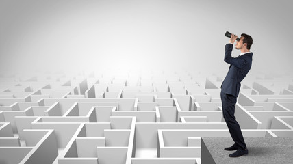 Wall Mural - businessman standing on maze and looking forward to the future concept