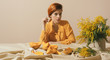 © Marko/Stocksy - Stylish ginger female in yellow outfit and set up.