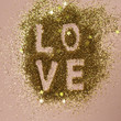 © Ani_Q/Stocksy - The word LOVE on glitter