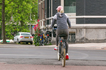 Unknown girl on bike in the center of of Amsterdam, Netherlands.