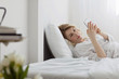 © Lumina/Stocksy - Woman Using Cell Phone in Her Bed