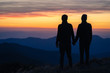 © realstock1 - The silhouette of the couple on the mountain with a sunset background