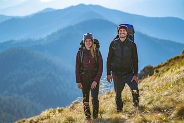 the attractive couple standing on the mountain