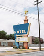 © jessemorrow/Stocksy - vintage hotel vacation sign roadside usa