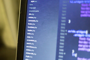 Web development project file system. PHP scripts dashboard on laptop screen.