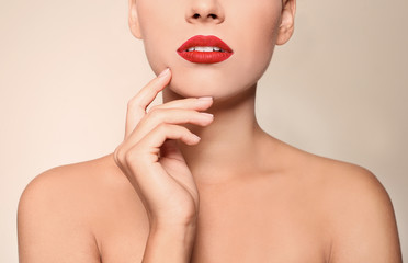 Poster - Beautiful young woman with red lips on color background, closeup