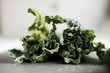 © deer/Stocksy - Kale cabbage leaves on a clean grey background