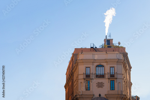 Old Town House In Winter With A Fireplace And Smoke From A Chimney