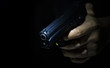 Gunman holding gun with dark background