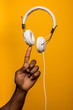 © victortorres/Stocksy - Concept shot of black man doing balance with white headphones