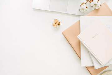 Wall Mural - Laptop, notebook, cotton branch on white background. Flat lay, top view minimal home office desk workspace.