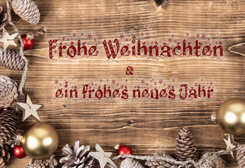 chirstmas frame with red and gold balls and pine cones with german text frohe weihnachten & ein frohes neues Jahr, in english merry christmas & a happy new year