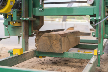 Sawmill. Process of machining logs in equipment sawmill machine saw saws the tree trunk on the plank boards. Wood sawdust work sawing timber wood wooden woodworking