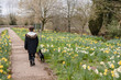 © RebeccaSpencer/Stocksy - Taking the dog for a walk through an English village in Spring