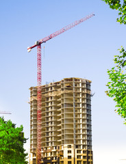 Tower crane and modern buildings under construction