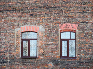 Two new windows in an old brick wall. Old building in the center of St. Petersburg, Russia.