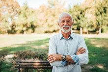 Portrait Of A Smiling Older Man In The Park.